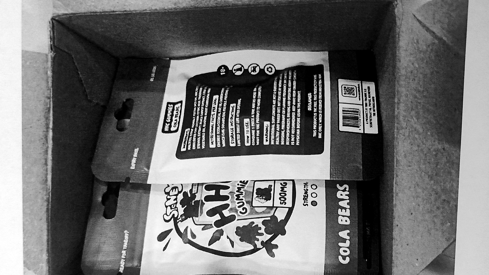 A photocopied page from the Swedish customs file showing the opened parcel: a cardboard box holding two resealable pouches of Stoney HHC cola-bear gummies.